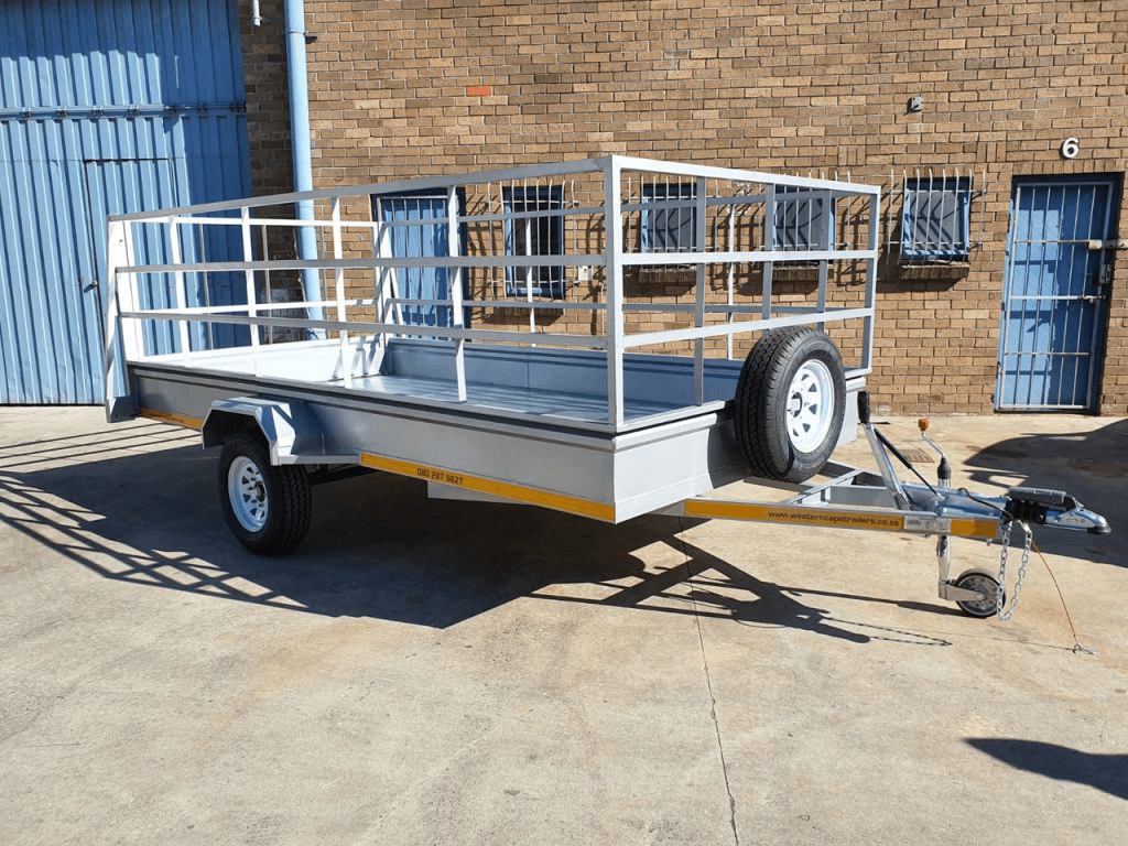 Galvanised caged utility trailer parked in a yard
